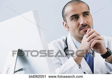 Stock Image - Lebanese male doctor thinking. Fotosearch