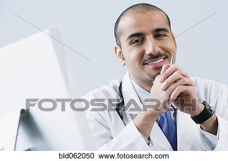 Lebanese male doctor with computer View Large Photo Image Stock Image - Lebanese male doctor with computer. Fotosearch