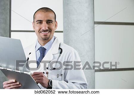 Lebanese male doctor with medical chart View Large Photo Image Stock Image - Lebanese male doctor with medical chart. Fotosearch