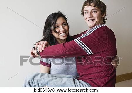 Stock Photo - Middle Eastern woman holding boyfriend. Fotosearch