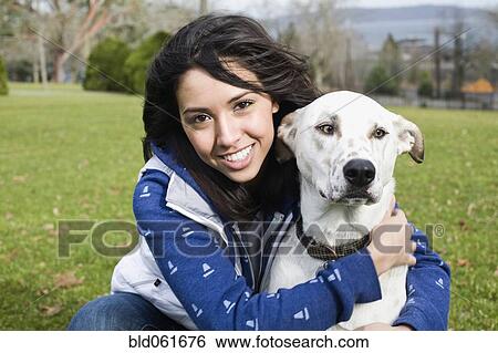 Middle Eastern woman hugging dog View Large Photo Image Stock Photograph - Middle Eastern woman hugging dog. Fotosearch