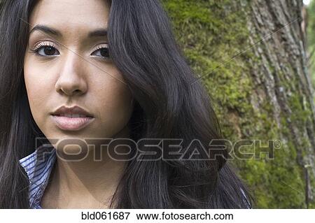 Stock Photo - Middle Eastern woman in front of tree. Fotosearch