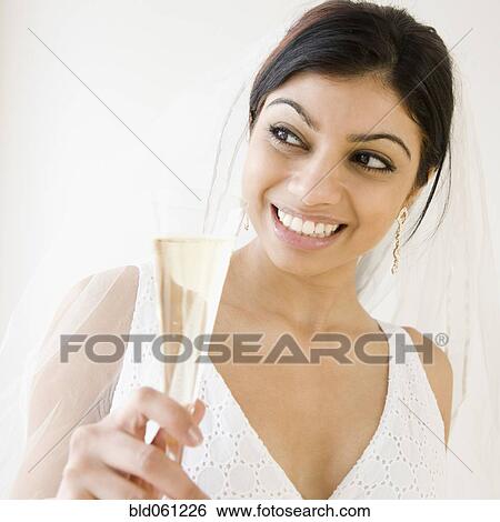 Mixed Race bride holding champagne glass View Large Photo Image Stock Photograph - Mixed Race bride holding champagne glass . Fotosearch