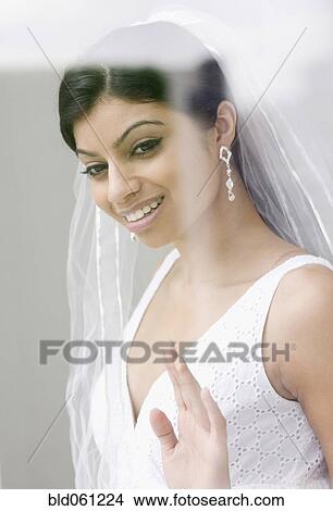 Mixed Race bride looking out window View Large Photo Image Picture - Mixed Race bride looking out window . Fotosearch