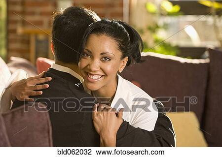 Mixed race couple hugging View Large Photo Image Stock Image - Mixed race couple hugging. Fotosearch