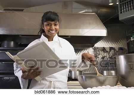 Mixed Race female baker mixing batter View Large Photo Image Stock Photograph - Mixed Race female baker mixing batter. Fotosearch