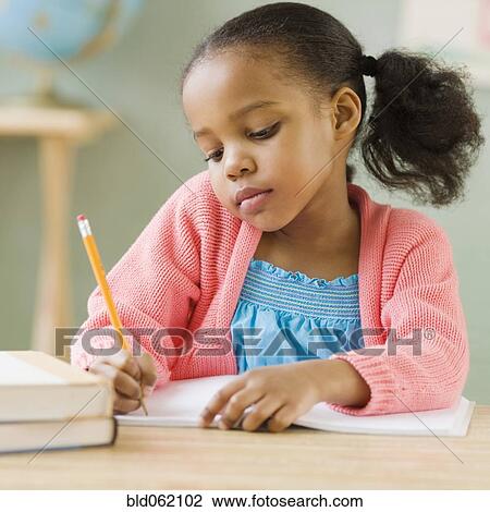 Mixed race girl doing school work View Large Photo Image Stock Image - Mixed race girl doing school work. Fotosearch