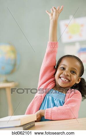 Mixed race girl raising hand to answer question View Large Photo Image Stock Image - Mixed race girl raising hand to answer question. Fotosearch