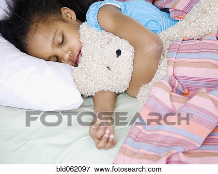 Mixed race girl sleeping with teddy bear View Large Photo Image Stock Photo - Mixed race girl sleeping with teddy bear. Fotosearch