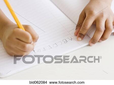 Picture - Mixed race girl writing ABC’s. Fotosearch
