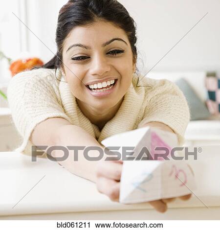 Stock Image - Mixed Race woman holding origami fortune teller. Fotosearch