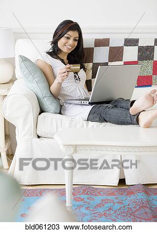 Mixed Race woman shopping online View Large Photo Image Stock Image - Mixed Race woman shopping online. Fotosearch