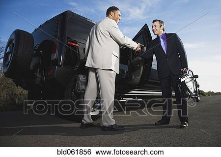 Multi-ethnic businessmen shaking hands View Large Photo Image Stock Photograph - Multi-ethnic businessmen shaking hands. Fotosearch