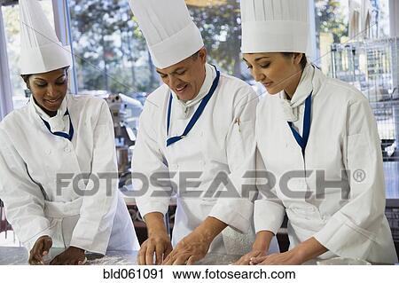 Multi-ethnic chefs preparing food View Large Photo Image Stock Image - Multi-ethnic chefs preparing food. Fotosearch