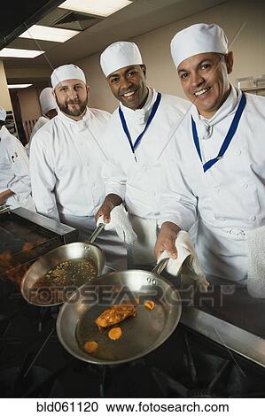 Multi-ethnic chefs preparing food View Large Photo Image Stock Image - Multi-ethnic chefs preparing food. Fotosearch