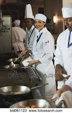Stock Image - Multi-ethnic chefs preparing food. Fotosearch