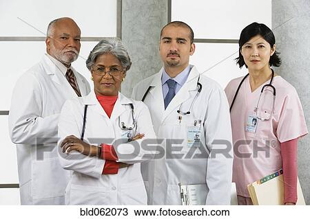 Multi-ethnic doctors and nurse posing View Large Photo Image Stock Image - Multi-ethnic doctors and nurse posing. Fotosearch
