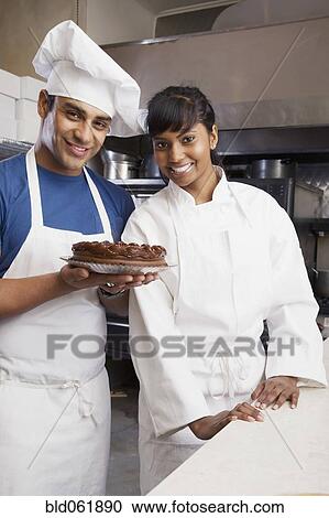 Multi-ethnic pastry chefs with cake View Large Photo Image Stock Image - Multi-ethnic pastry chefs with cake. Fotosearch