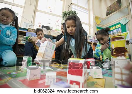 Picture - Multi-ethnic students in classroom. Fotosearch