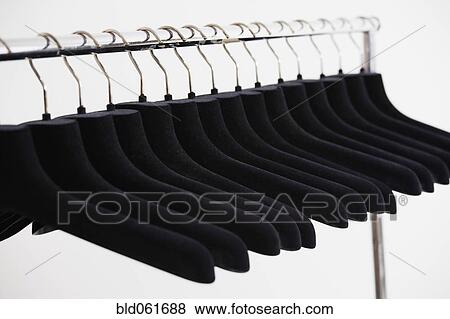 Row of empty clothing hangers on rack View Large Photo Image Stock Photo - Row of empty clothing hangers on rack. Fotosearch