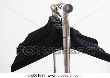 Row of empty clothing hangers on rack View Large Photo Image Stock Photo - Row of empty clothing hangers on rack. Fotosearch