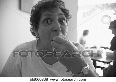 Stock Photo - Senior woman eating . Fotosearch