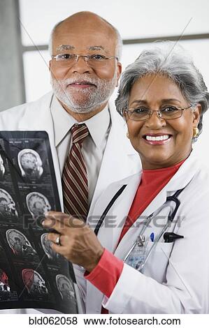 Stock Photo - Two African doctors examining x-rays. Fotosearch