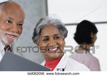 Two African doctors talking together View Large Photo Image Stock Photograph - Two African doctors talking together. Fotosearch