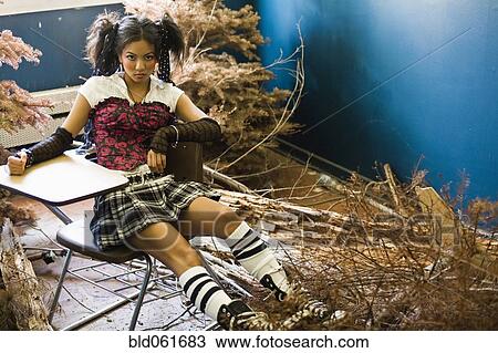 Young Asian woman in school desk next to dead trees View Large Photo Image Stock Image - Young Asian woman in school desk next to dead trees. Fotosearch