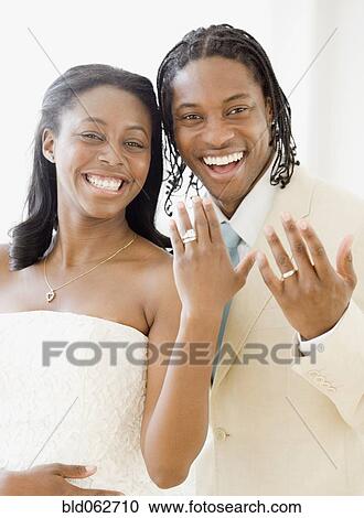 African bride and groom showing wedding rings View Large Photo Image Stock Image - African bride and groom showing wedding rings. Fotosearch