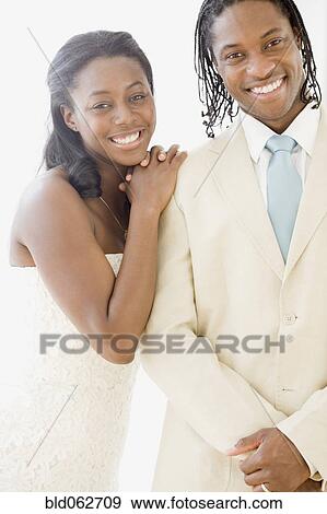 African bride and groom smiling View Large Photo Image Stock Photo - African bride and groom smiling. Fotosearch