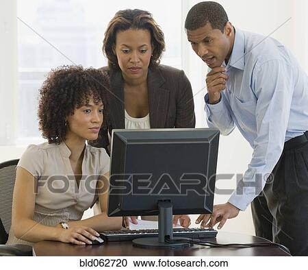 Stock Image - African business people working on computer. Fotosearch