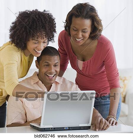 Stock Photograph - African business people working on laptop. Fotosearch