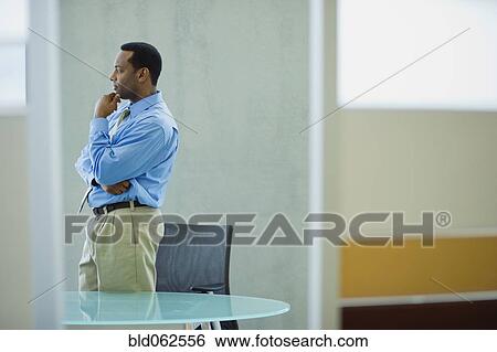 African businessman looking pensive in office View Large Photo Image Stock Photograph - African businessman looking pensive in office. Fotosearch