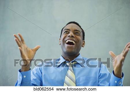 African businessman smiling and gesturing View Large Photo Image Picture - African businessman smiling and gesturing. Fotosearch