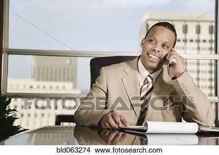 African businessman talking on cell phone View Large Photo Image Picture - African businessman talking on cell phone. Fotosearch