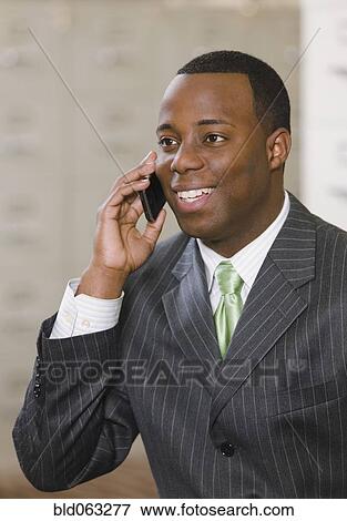 African businessman talking on cell phone View Large Photo Image Stock Photo - African businessman talking on cell phone. Fotosearch