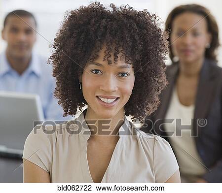 Stock Image - African businesswoman and co-workers. Fotosearch