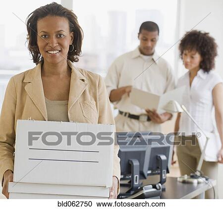 African businesswoman holding box View Large Photo Image Stock Image - African businesswoman holding box. Fotosearch