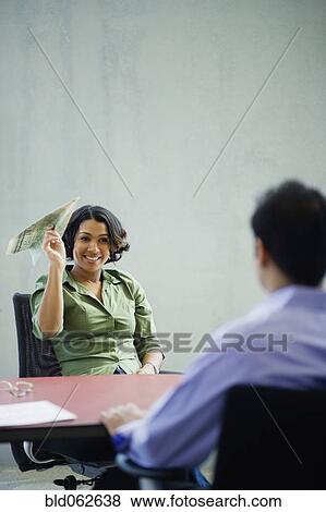 Stock Photo - African businesswoman holding money paper airplane. Fotosearch