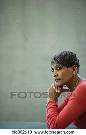 Stock Image - African businesswoman looking pensive. Fotosearch