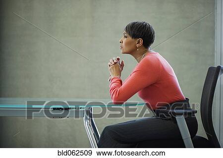 African businesswoman looking serious at conference table View Large Photo Image Stock Photo - African businesswoman looking serious at conference table. Fotosearch