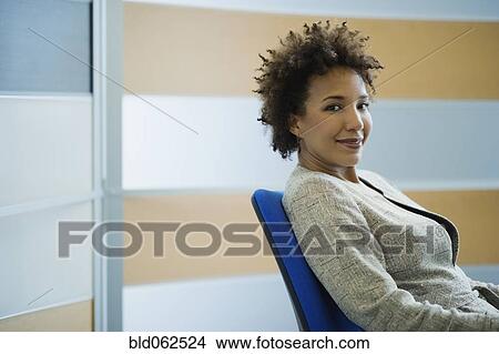 African businesswoman sitting in chair View Large Photo Image Picture - African businesswoman sitting in chair. Fotosearch