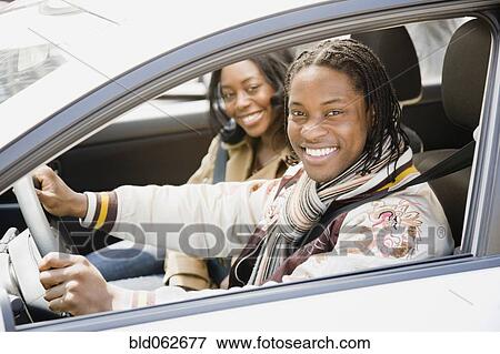 Stock Photo - African couple driving in car. Fotosearch