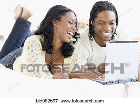 African couple on laptop in bed View Large Photo Image Stock Photo - African couple on laptop in bed. Fotosearch