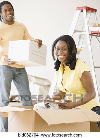 African couple packing moving boxes View Large Photo Image Picture - African couple packing moving boxes. Fotosearch