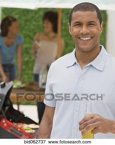 African man and women barbecuing View Large Photo Image Stock Photo - African man and women barbecuing. Fotosearch