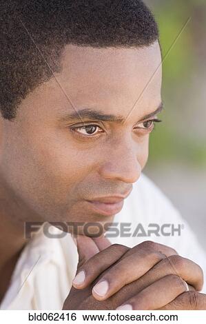 Stock Photograph - African man looking pensive. Fotosearch