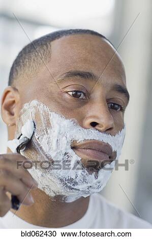 Stock Image - African man shaving. Fotosearch