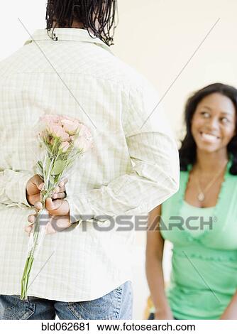 African man surprising woman with flowers View Large Photo Image Stock Image - African man surprising woman with flowers. Fotosearch